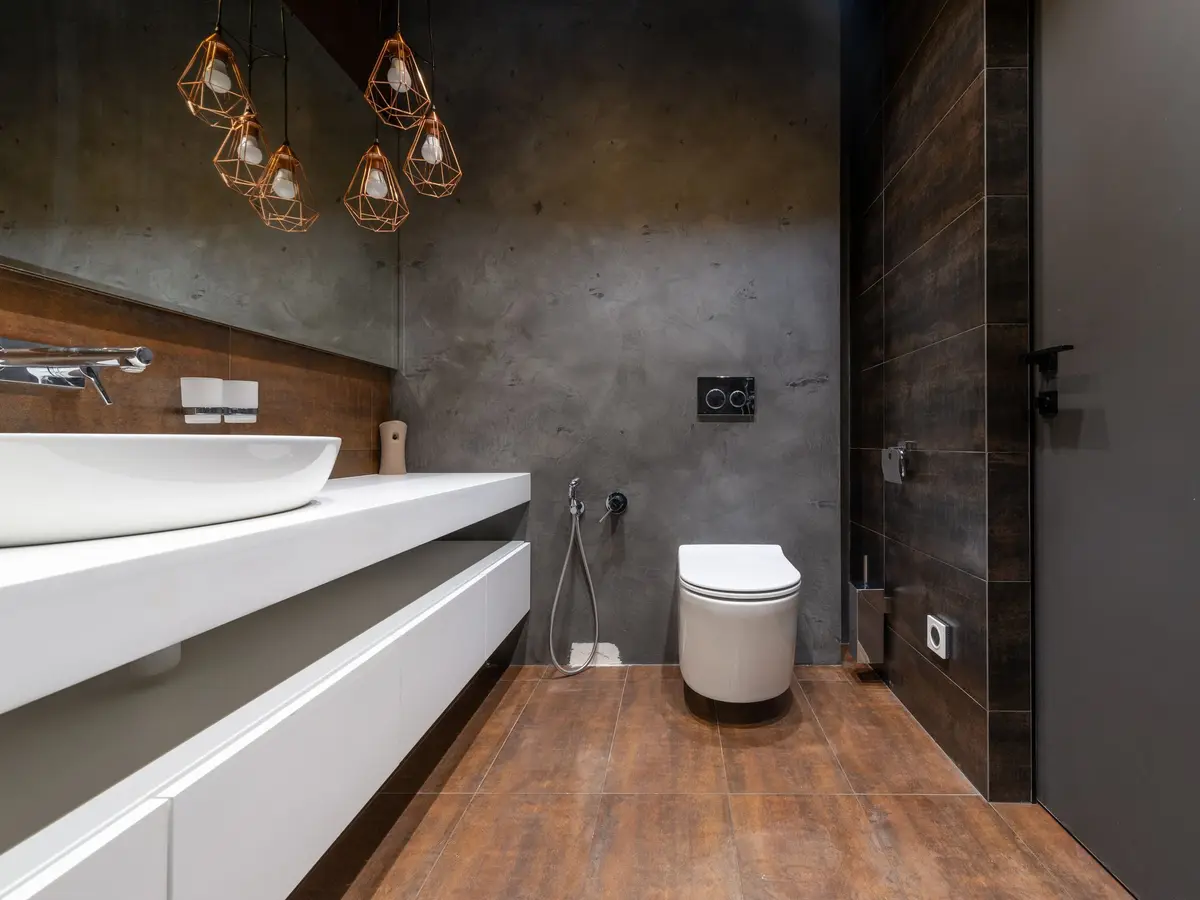 Bathroom with dark polished-effect walls and a wooden floor