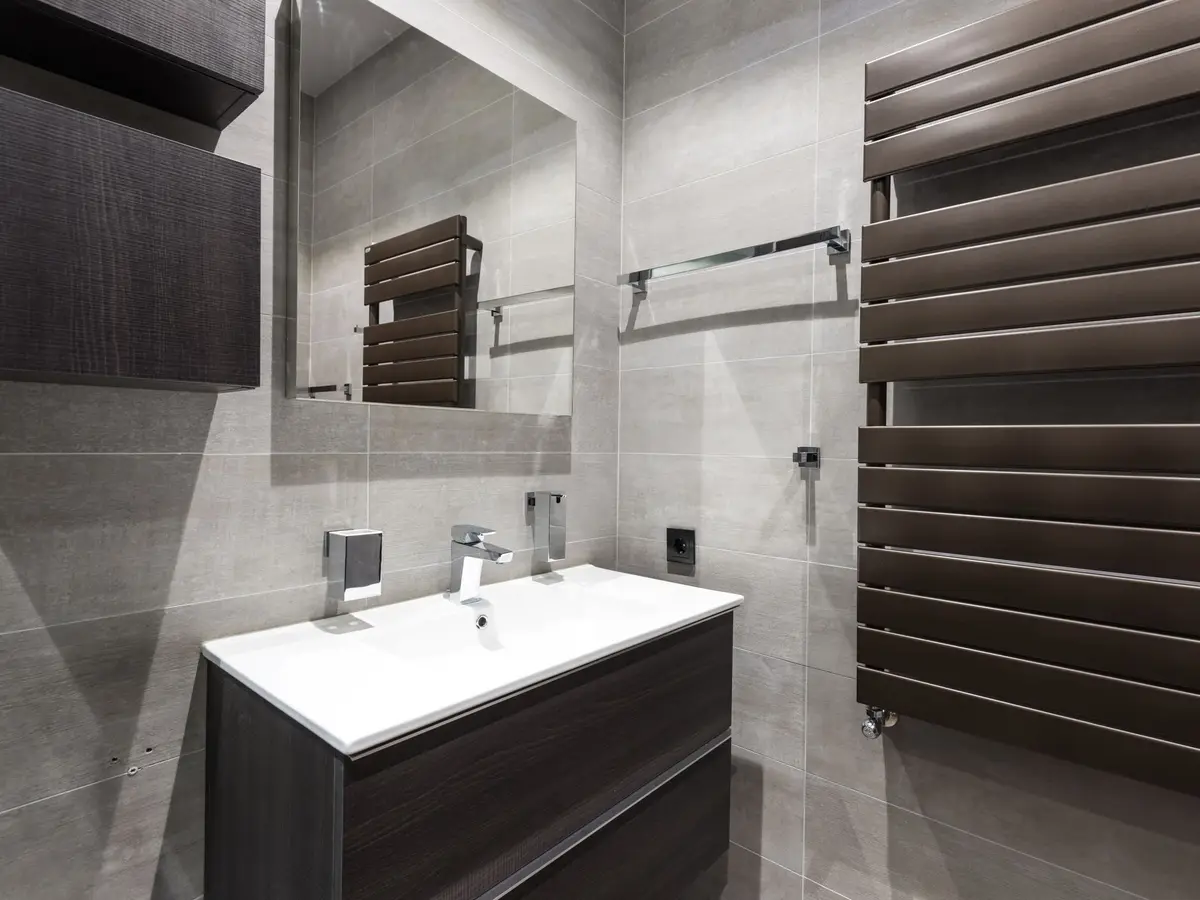 Grey bathroom with a towel radiator and a wall-hung vanity