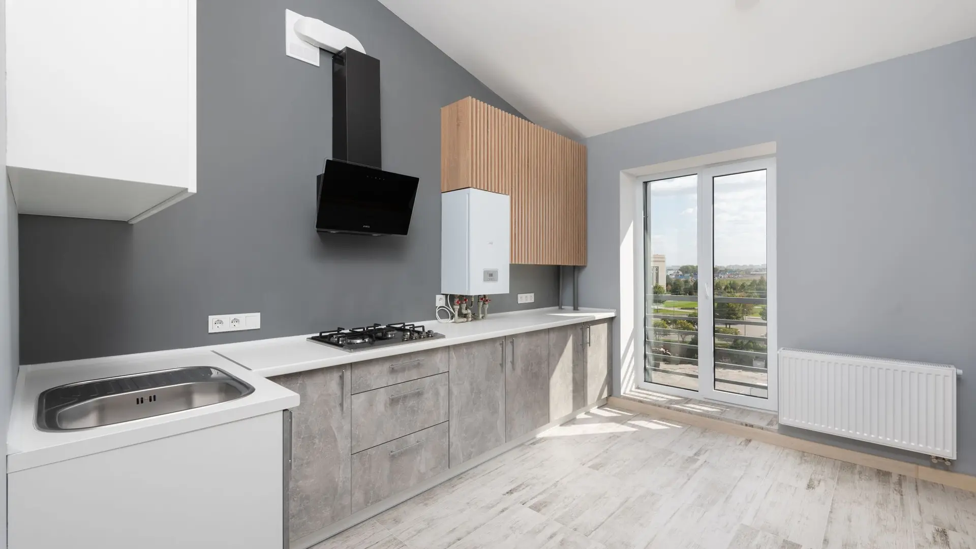Modern kitchen with smooth grey walls and a glazed door