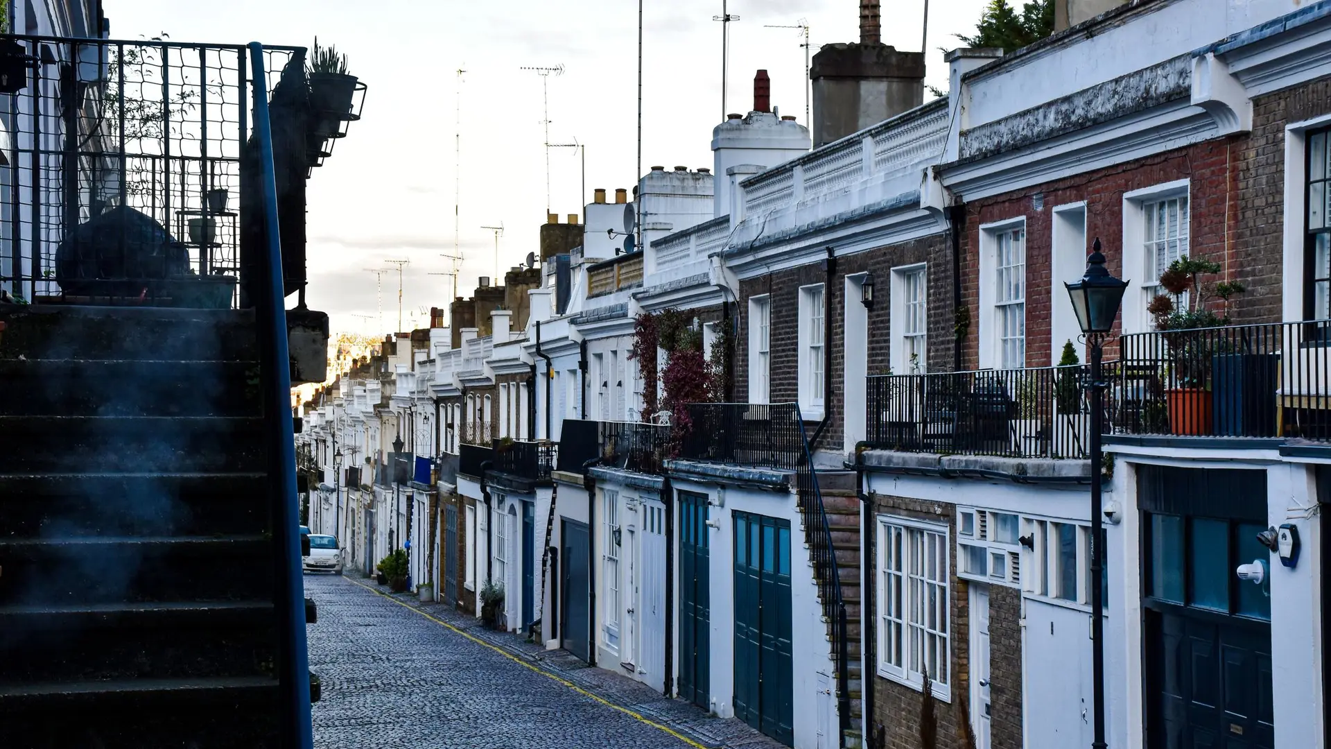 Cobbled mews lined with painted and brick houses