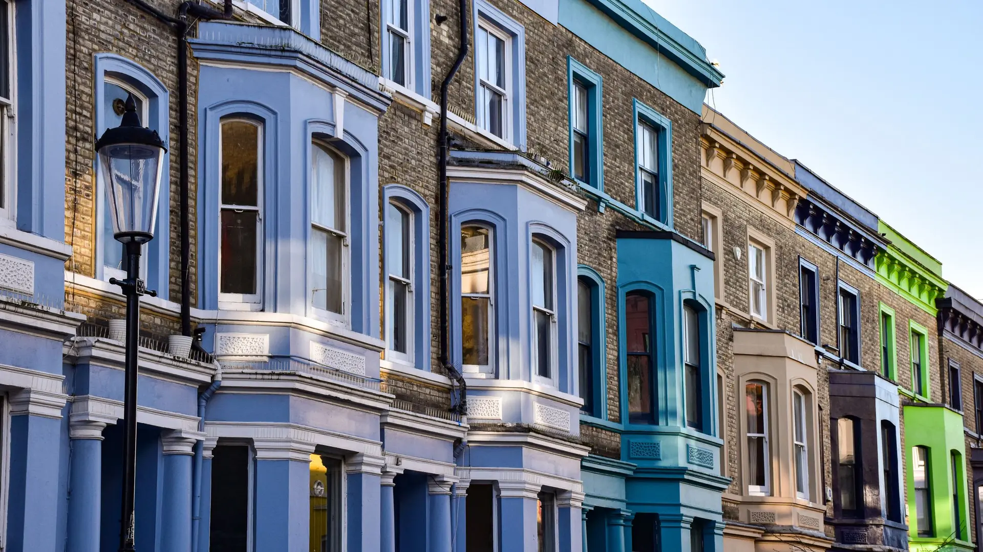 Terraced houses with bay fronts painted in different colours